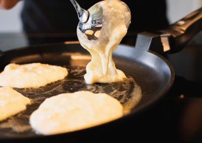 Light And Fluffy Buttermilk Pancakes Filling Batter Into Pan