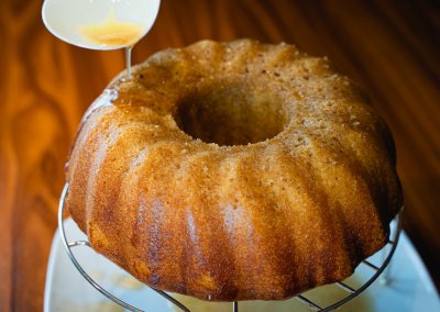 Moist Cinnamon Bundt Cake Puring Cinnamon Syrup Glaze Over Cake
